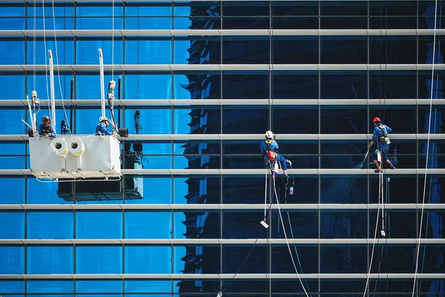 workers, windows, building, cleaners, cleaning, service, maintenance, crane cradle, glass, reflection, high-rise building, skyscraper, urban, city, workers, workers, cleaning, cleaning, cleaning, cleaning, cleaning, service, maintenance, maintenance, maintenance. Building a hiring process for commercial cleaning crews that actually holds